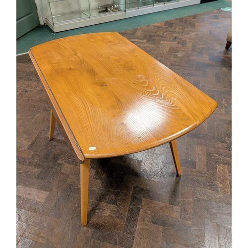 7 - An Ercol blond elm drop leaf circular dining table, 44