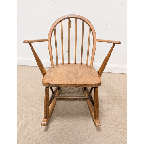 9 - A 1950's Ercol child's size blond elm spindle back rocking elbow chair...