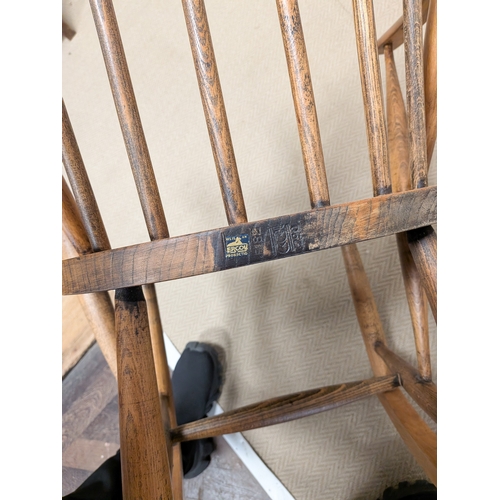 9 - A 1950's Ercol child's size blond elm spindle back rocking elbow chair...
