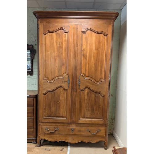 375 - A chateau sized antique French chestnut armoire with two fielded panel doors and one drawer under wi... 