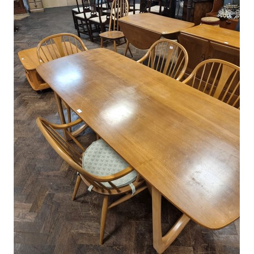 3 - Ercol  - a set of four Cowhorn 524 blond elm elbow or carver chairs with loose blue patterned cushio...