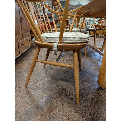 3 - Ercol  - a set of four Cowhorn 524 blond elm elbow or carver chairs with loose blue patterned cushio...