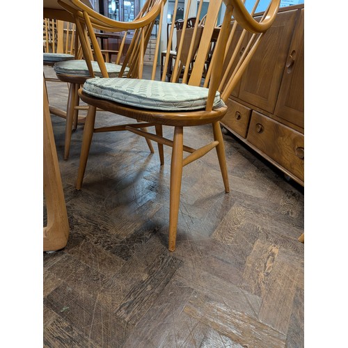 3 - Ercol  - a set of four Cowhorn 524 blond elm elbow or carver chairs with loose blue patterned cushio...