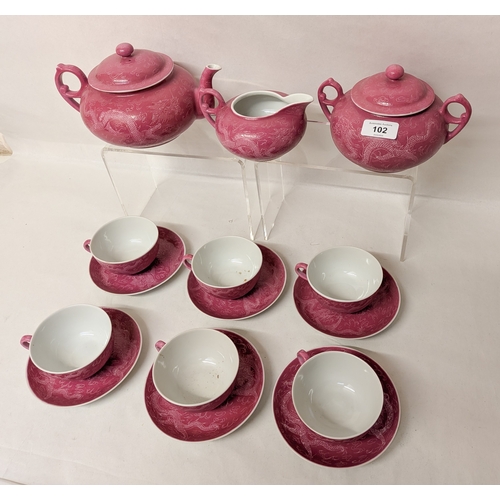 102 - A Chinese pink ground and Sgraffito decorated tea service with six character marks to the bases