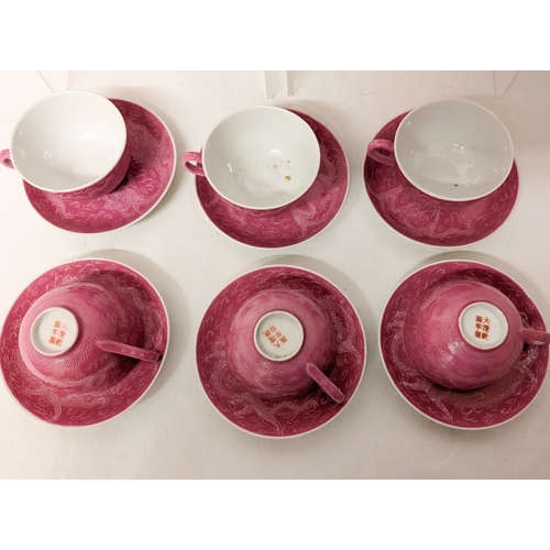 102 - A Chinese pink ground and Sgraffito decorated tea service with six character marks to the bases