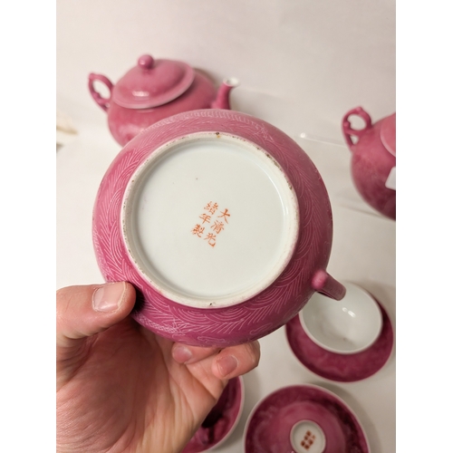 102 - A Chinese pink ground and Sgraffito decorated tea service with six character marks to the bases