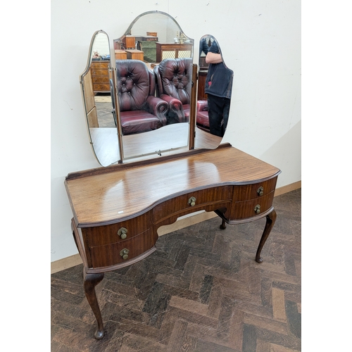 31 - A walnut knee-hole kidney shaped dressing table with triple mirrors and a matching chest of five lon... 