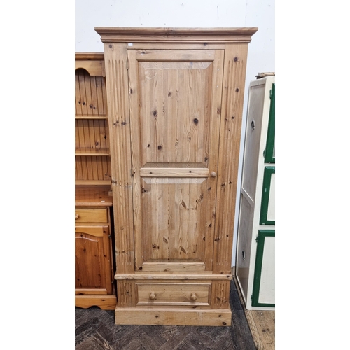 37 - A pine single door wardrobe with drawer under, 31