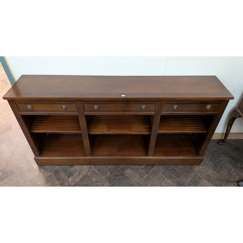 46 - A long Georgian style mahogany bookcase or sideboard fitted three drawers and shelves with cross ban... 