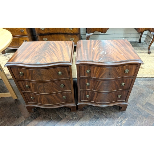 51 - A pair of small Georgian style mahogany serpentine fronted bedside chests, each fitted three drawers... 