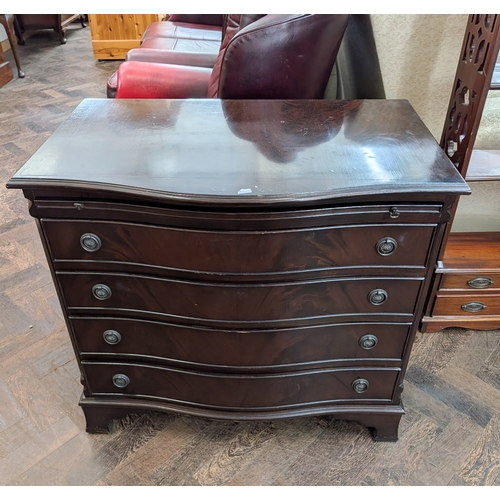 57 - A Georgian style mahogany serpentine fronted bachelors chest fitted four drawers and brushing slide,... 