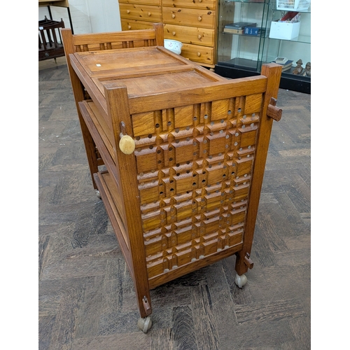 59 - A three tier teak tea trolley with lift out tray
