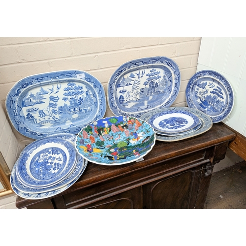 66 - A collection of blue and white oval meat plates together with a circular Persian design wall charger