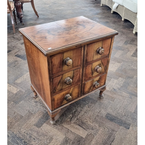 88 - A figured walnut chest of six drawers, standing on cabriole feet, 25
