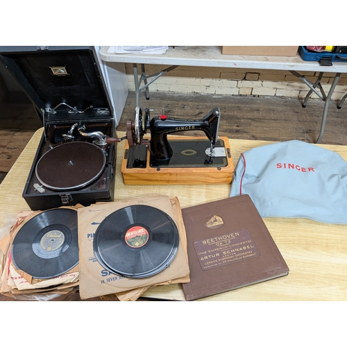 A HMV wind up portable gramophone with records together with a Singer ...