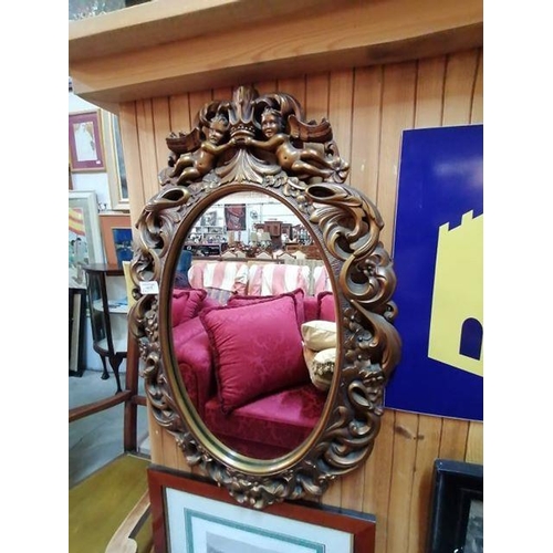 16 - Oval Gilt Mirror with Cherubs (Approx 67cm x 46cm with Frame and 47cm x 28cm without frame, Believed... 