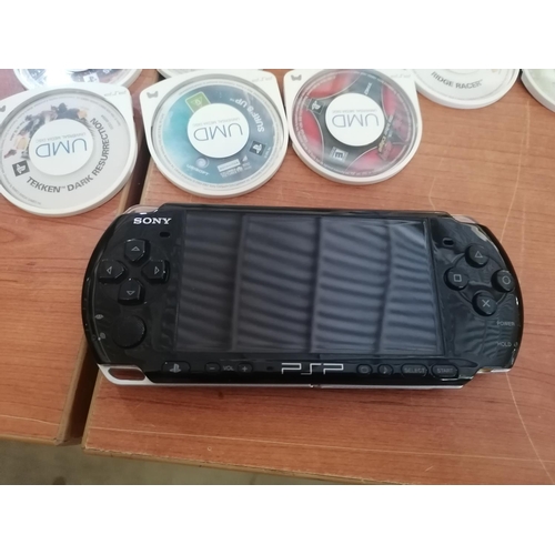 219 - PSP (Needs New Battery) and 12 x Games, Charger and TV Extension, Case