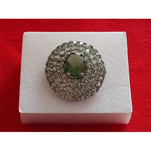 244 - White Metal Ring with Large Oval Light Green Stone and Quantity of Small Stones Size P/Q (17/18)