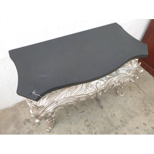 105 - A Console Table, Shaped Black Top on an Eleborate Silvered Base (120cm x 6cm x H:83cm) (Ref: FUR 801... 