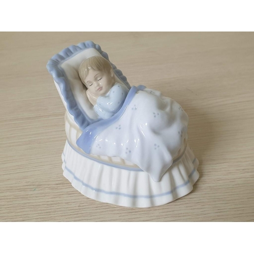 215 - A Lovely Porcelain Figurine of a Sleeping Baby in a Crib by Leonardo Collection (POR 749)