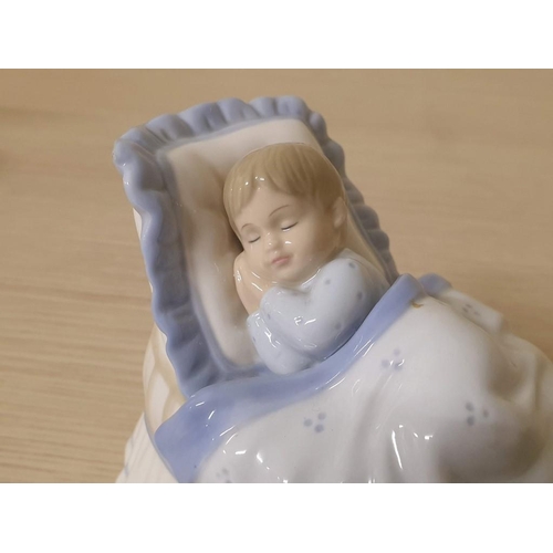 215 - A Lovely Porcelain Figurine of a Sleeping Baby in a Crib by Leonardo Collection (POR 749)