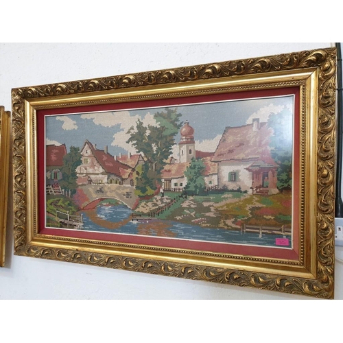 307 - Large Tapestry of Riverside Village Scene in Decorative Gilt Frame (118cm x 68cm overall)