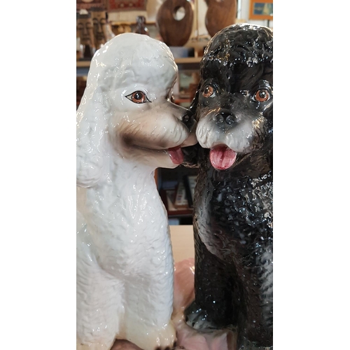 317 - Porcelain Poodle Dog Ornament; Pair of Black & White Puppies on Pink Cushion, (A/F), (H:40cm)