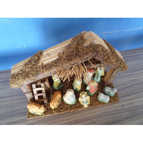 268 - Nativity Set with Wood and Straw Stable (L:35cm H:29cm) and Porcelain Figures (4cm-13cm)