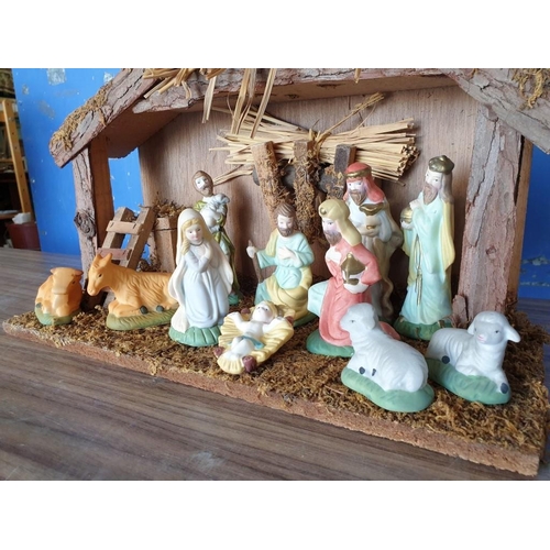 268 - Nativity Set with Wood and Straw Stable (L:35cm H:29cm) and Porcelain Figures (4cm-13cm)