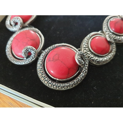 114 - Kostiba Hallas Decorative White Metal Necklace with Red Coral Effect Stones, Together with 2 x Bangl... 