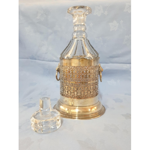 145 - Vintage Cut Glass Decanter in White Metal Holder Decorated with Lion's Head (H:33cm)