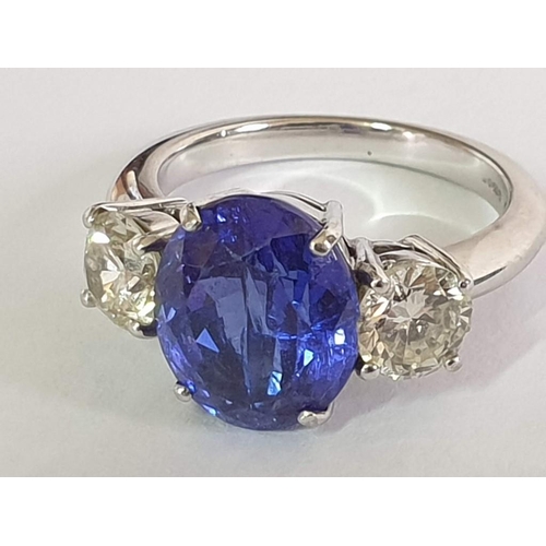 120A - 18ct Gold Tanzanite and Diamond Ring; 5.21ct Oval Cut Tanzanite (Approx 11.3 x 9.4mm Overall) with 2... 