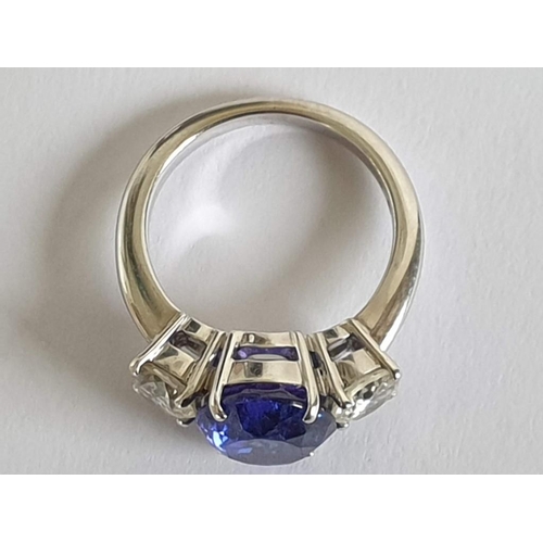 120A - 18ct Gold Tanzanite and Diamond Ring; 5.21ct Oval Cut Tanzanite (Approx 11.3 x 9.4mm Overall) with 2... 