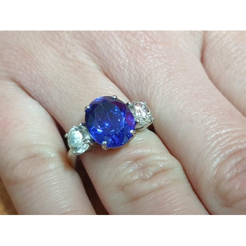 120A - 18ct Gold Tanzanite and Diamond Ring; 5.21ct Oval Cut Tanzanite (Approx 11.3 x 9.4mm Overall) with 2... 