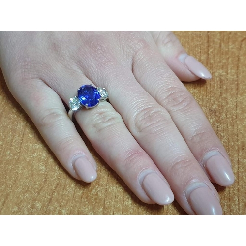 120A - 18ct Gold Tanzanite and Diamond Ring; 5.21ct Oval Cut Tanzanite (Approx 11.3 x 9.4mm Overall) with 2... 