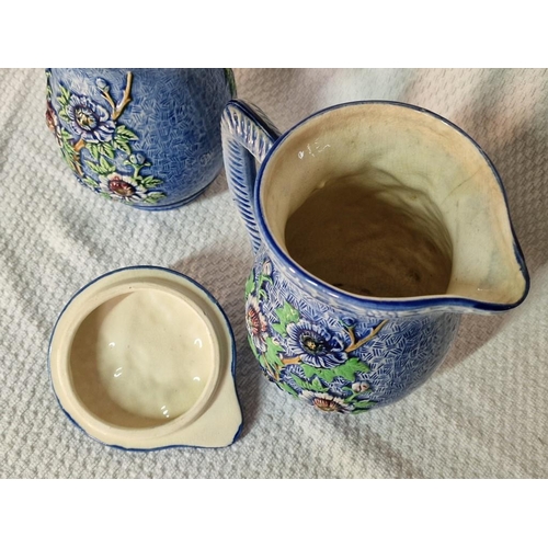 31 - Pair of Attractive Lidded Porcelain Jugs with Floral Decoration over Blue Pattern, (Approx. H: 22cm)... 