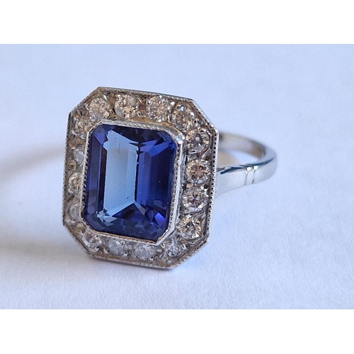 164 - Platinum, Tanzanite and Diamond Ring; Emerald Cut Tanzanite, (Approx. 9x7mm), with 16 x Round Cut Di... 