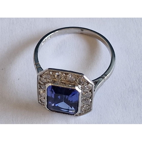 164 - Platinum, Tanzanite and Diamond Ring; Emerald Cut Tanzanite, (Approx. 9x7mm), with 16 x Round Cut Di... 