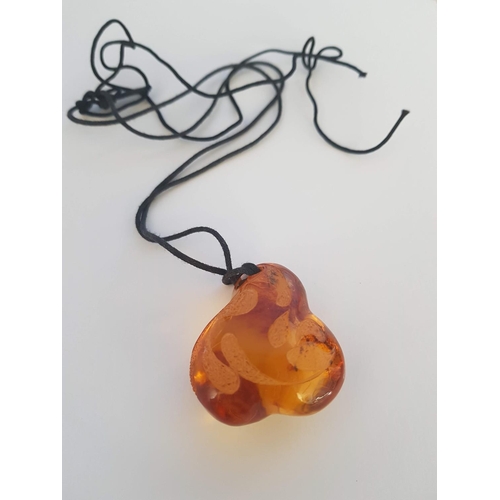 149 - Lathe Unique Amber (?) Pendant on String (Approx 4.5 x 3.5cm)