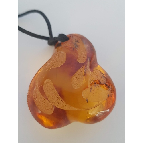 149 - Lathe Unique Amber (?) Pendant on String (Approx 4.5 x 3.5cm)