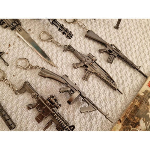 119 - Large Collection of Assorted Key Rings with Ornamental Guns, Rocket Launcher, Knives, etc (18)