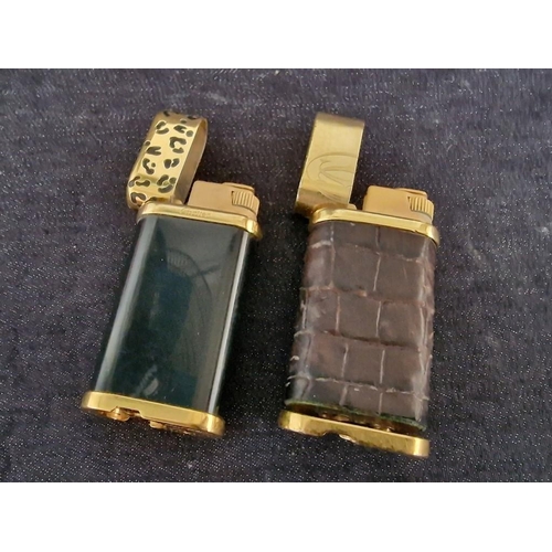 110 - 2 x Cartier Trinity Lighters; Gold Plated with Black Lacquer and Leather Clad, (A/F, Nb. Both Missin... 