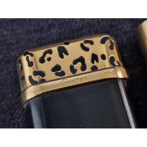 110 - 2 x Cartier Trinity Lighters; Gold Plated with Black Lacquer and Leather Clad, (A/F, Nb. Both Missin... 