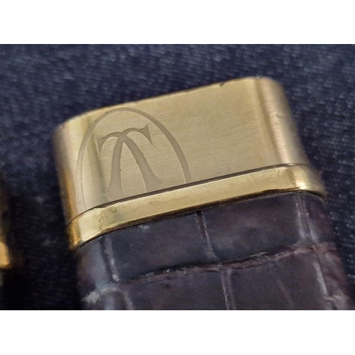 110 - 2 x Cartier Trinity Lighters; Gold Plated with Black Lacquer and Leather Clad, (A/F, Nb. Both Missin... 