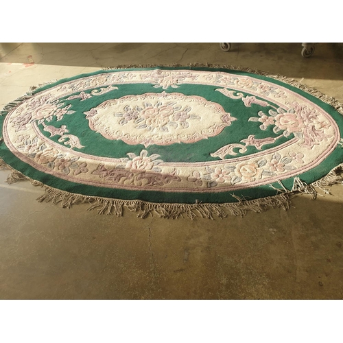 447 - Chinese Woollen Oval Carpet Pink / Blue Floral Pattern and Green Background (276 x 170cm)