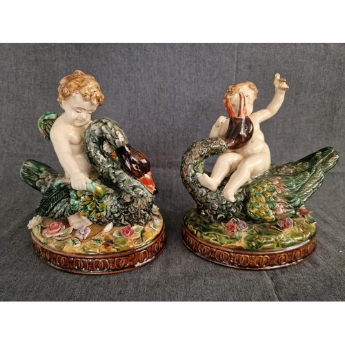 125 - 2 x Continental Style Porcelain Cherubs Playfully Riding Swans, (Approx. H: 22cm, Base: 20 x 15.5cm ... 