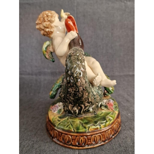 125 - 2 x Continental Style Porcelain Cherubs Playfully Riding Swans, (Approx. H: 22cm, Base: 20 x 15.5cm ... 