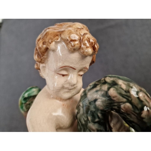 125 - 2 x Continental Style Porcelain Cherubs Playfully Riding Swans, (Approx. H: 22cm, Base: 20 x 15.5cm ... 