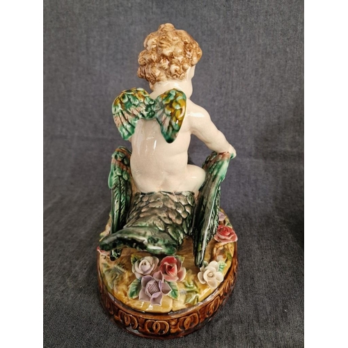 125 - 2 x Continental Style Porcelain Cherubs Playfully Riding Swans, (Approx. H: 22cm, Base: 20 x 15.5cm ... 