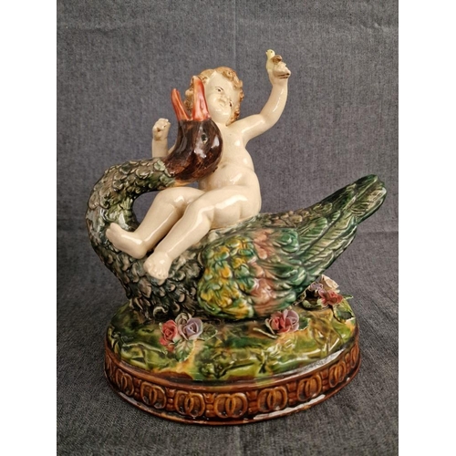 125 - 2 x Continental Style Porcelain Cherubs Playfully Riding Swans, (Approx. H: 22cm, Base: 20 x 15.5cm ... 